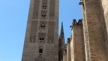 Una torre alta y antigua con detalles arquitectónicos elaborados y un cielo despejado.