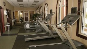 A gym with treadmills, stationary bikes, and a weight bench. - 4 BR Home in Prestigious Regal Palms Resort, waterpark, close to theme parks. (Davenport)