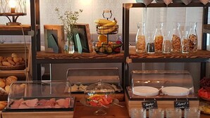 A buffet setup with various food items and beverages. - Loungehotel Seeterrassen Wandlitzsee (Wandlitz)