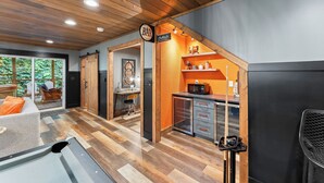 A modern kitchen with a microwave, oven, and a coffee machine.