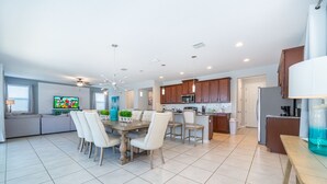 A modern kitchen with wooden cabinets, a microwave, and a refrigerator. - GB1737 Home 5/5 Private Pool & Jaccuzi, Free Waterpark (Kissimmee)