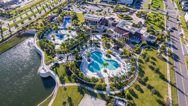 An aerial view of a resort with multiple swimming pools, a marina, and lush landscaping. - GB1737 Home 5/5 Private Pool & Jaccuzi, Free Waterpark (Kissimmee)
