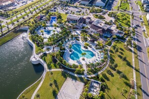 An aerial view of a resort with multiple swimming pools, a marina, and lush landscaping. - GB1737 Home 5/5 Private Pool & Jaccuzi, Free Waterpark (Kissimmee)