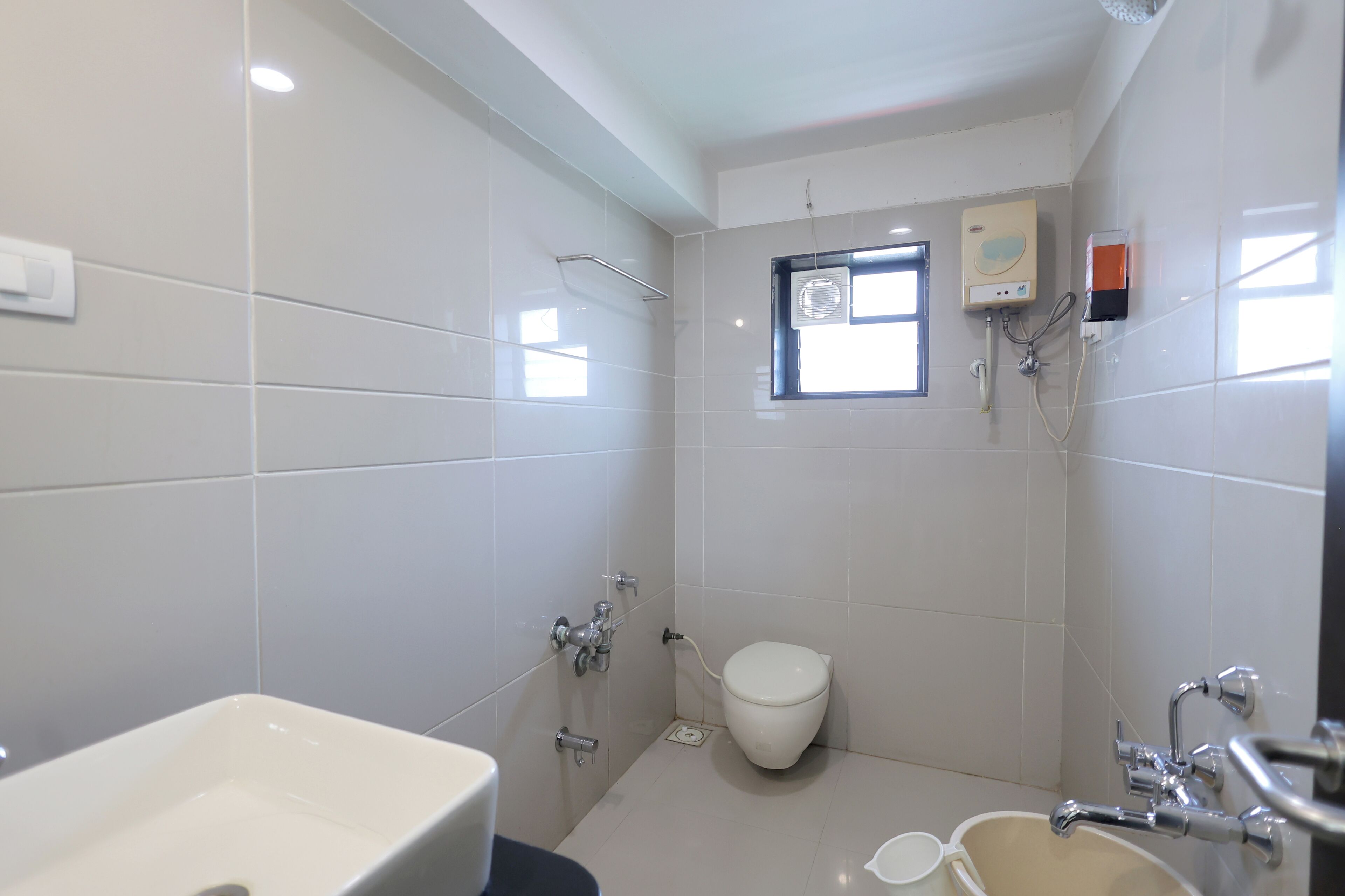 deluxe room | bathroom | shower, rainfall showerhead, towels