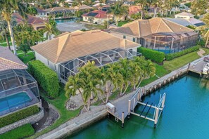 A residential area with houses, a swimming pool, and a dock.