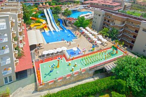 A hotel with a rooftop pool area featuring slides, a children's play area, and outdoor seating. - 07 Group Hotel (Alanya)