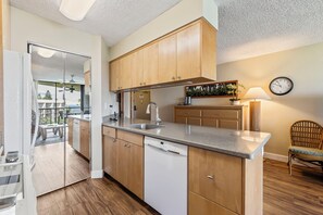 Enjoy cooking in this well-lit kitchen with an island and dishwasher.