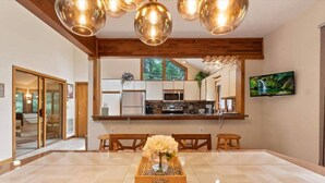 A modern kitchen with wooden cabinets, stainless steel appliances, and a large window. - Pocono Pines Family Retreat: Game Room, Sunroom & Pets Welcome! (Pocono Pines)