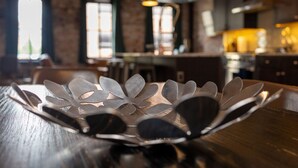 A metal decorative bowl on a wooden table in a restaurant setting.