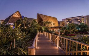 Experience the tranquil atmosphere of this unique resort, surrounded by lush tropical vegetation and a serene boardwalk.