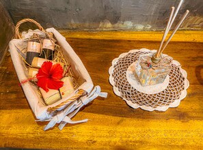 A wicker basket with toiletries and a decorative item on a wooden surface.