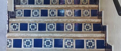 A staircase with blue and white patterned tiles.