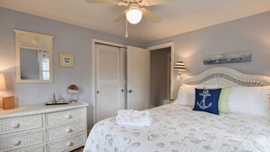 A bedroom with a bed, a dresser, a mirror, and a ceiling fan. - 1/2 Mile to Nantucket Sound Beaches! (Dennis Port)