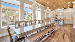 A spacious kitchen with a large island, wooden ceiling, and large windows. - 7BR Gulf Views, Large Private Pool/Spa, Private Beach/Gated Community, Sleeps 20 (Destin)