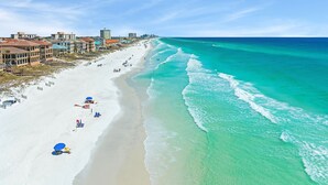 A beach with white sand, clear turquoise water, and buildings along the shore. - 7BR Gulf Views, Large Private Pool/Spa, Private Beach/Gated Community, Sleeps 20 (Destin)