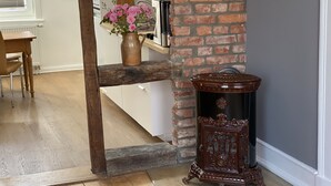 A kitchen with a brick wall, wooden beam, and a decorative urn. - Center, modern renovated old town apartment, Torster #3 (Hameln)