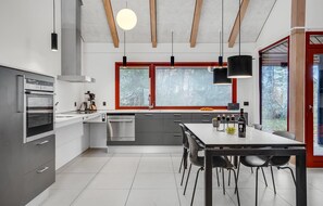 Enjoy cooking in this well-equipped kitchen with oven, dishwasher, and dining area.