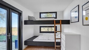 A bunk bed room with a ladder, a desk, and a window. - Cozy home in Hadsund with WiFi (Hadsund)