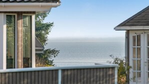 A coastal view with a house and a wooden fence in the foreground. - Gorgeous home in Grevinge with kitchen (Grevinge)