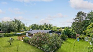 A modern house with a large garden, a patio with outdoor furniture, and a solar panel. - Gorgeous home in Grevinge with kitchen (Grevinge)