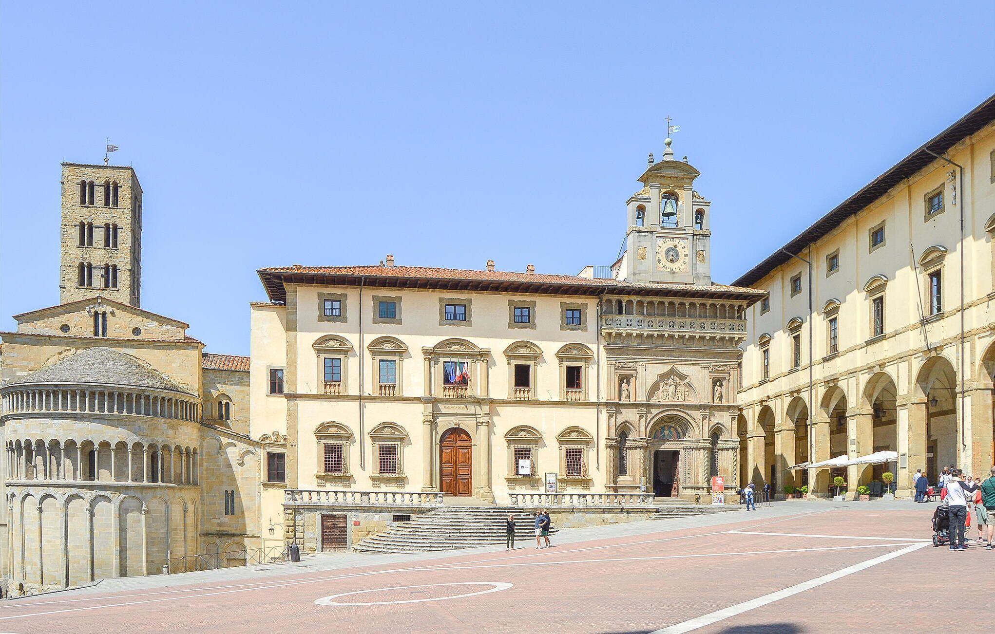 A historic building with a central courtyard, a clock tower, and a bell tower.