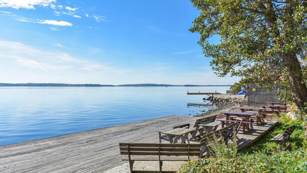 A wooden pier extending into calm water with a clear sky above. - 2 bedroom amazing home in Kolmården (Kolmården)