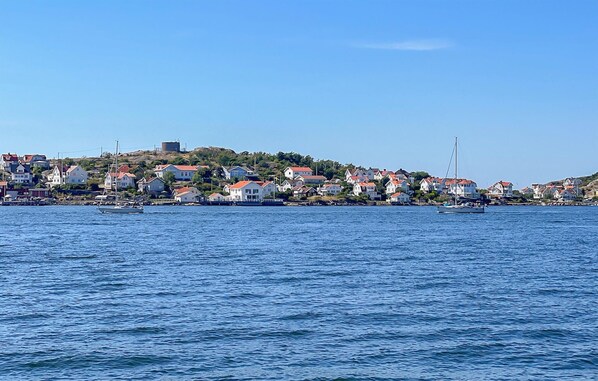A coastal town with houses along the shoreline, a lighthouse, and boats in the water. - 7 bedroom gorgeous home in Bohus-Björkö (Bohus-Björkö)
