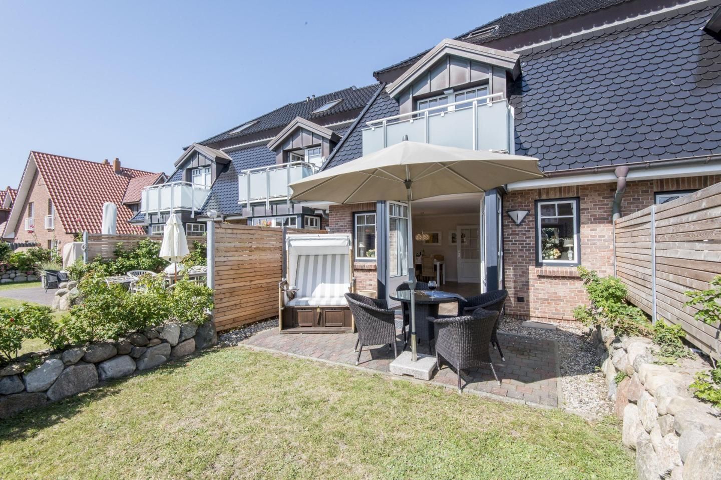 A residential property with a patio area featuring outdoor furniture and a covered seating area.