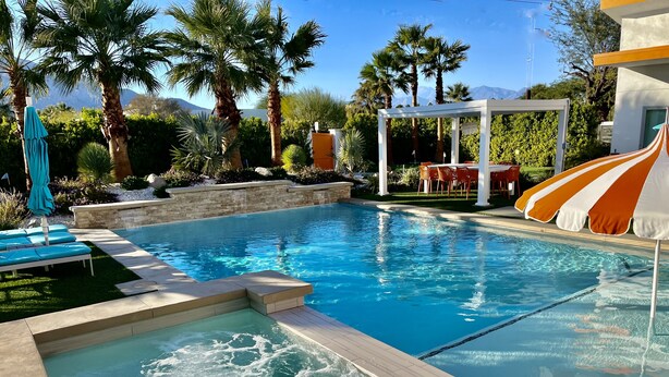 A swimming pool with a hot tub, lounge chairs, and a covered seating area. - PS Playground - Putt Chip - Horseshoe - Corn Hole - Pool Table (Palm Springs)