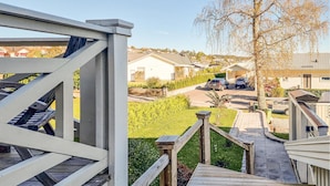 A residential area with a wooden deck and a pathway leading to houses.