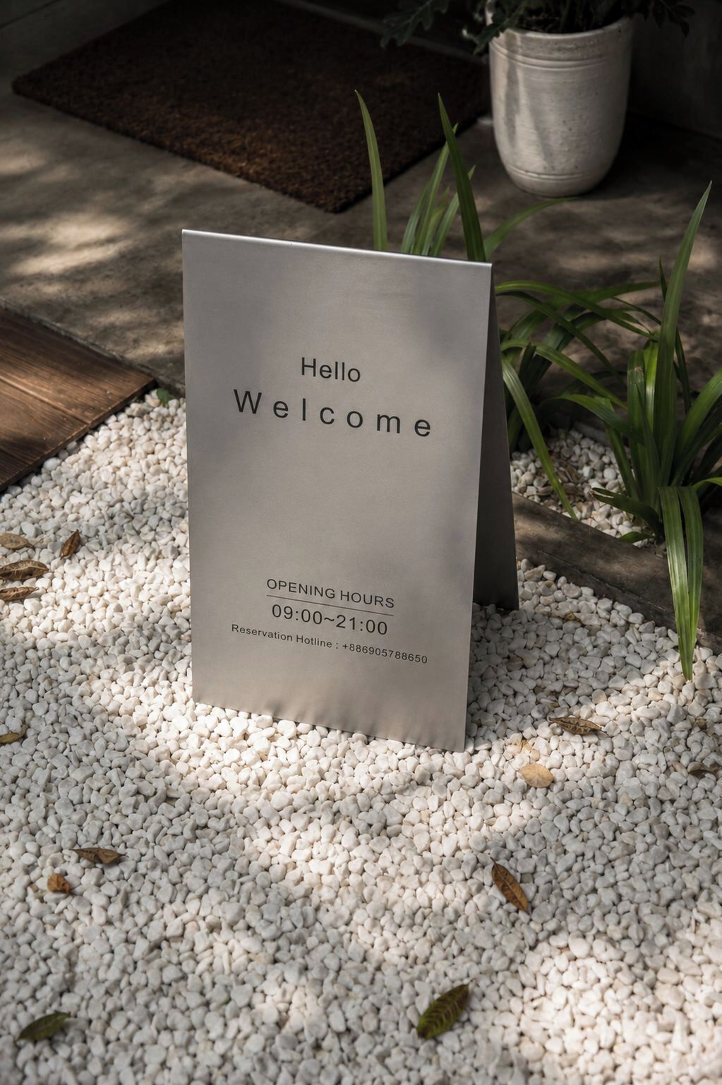 A 'Hello Welcome' sign with opening hours and a reservation hotline number on a white background.