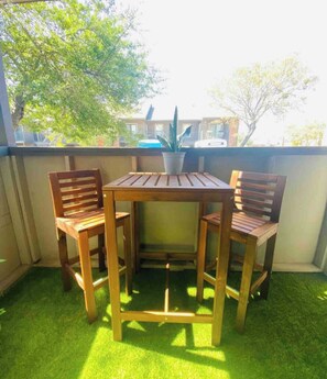 Sit and unwind in this serene outdoor space with a table and two chairs.