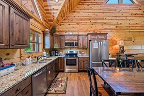 Cozy kitchen with stainless steel appliances, granite countertops, and ample storage.