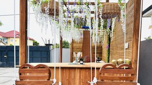 A wooden bar area with hanging baskets and a bottle of wine. - Luxury Escape w/ Infinity Pool & Hot Tub Bar (Adenta)