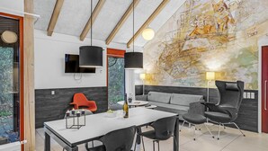 A modern room with a dining area, a sofa, and a large abstract mural on the wall. - Awesome home in Grenaa with WiFi (Grenaa)