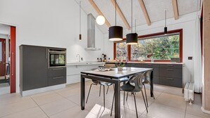 A modern kitchen with a central island, built-in oven, and pendant lighting. - Awesome home in Grenaa with WiFi (Grenaa)
