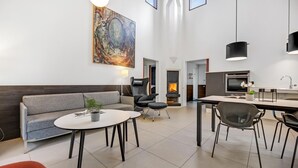 A modern living room with a sofa, a round table, and a fireplace. - Awesome home in Grenaa with WiFi (Grenaa)