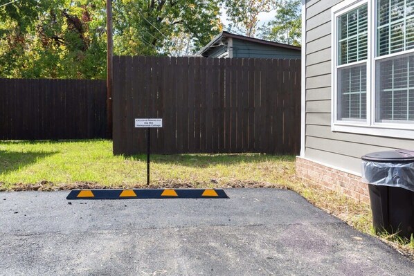 A parking area with a sign indicating it is for Old Mill B&B.