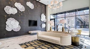 Relax in this stylish living room with a large flat-screen TV, comfortable sofa, and beautiful views of the outside.