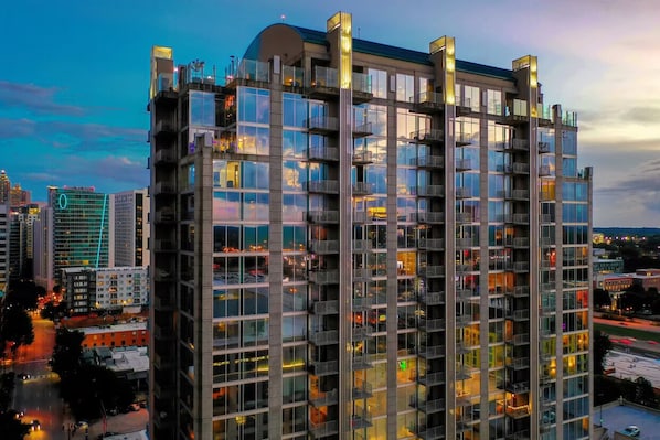 Stunning high-rise building with a grid of windows and balconies, offering city views.