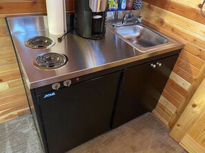 Fridge, microwave, coffee/tea maker, cookware/dishes/utensils