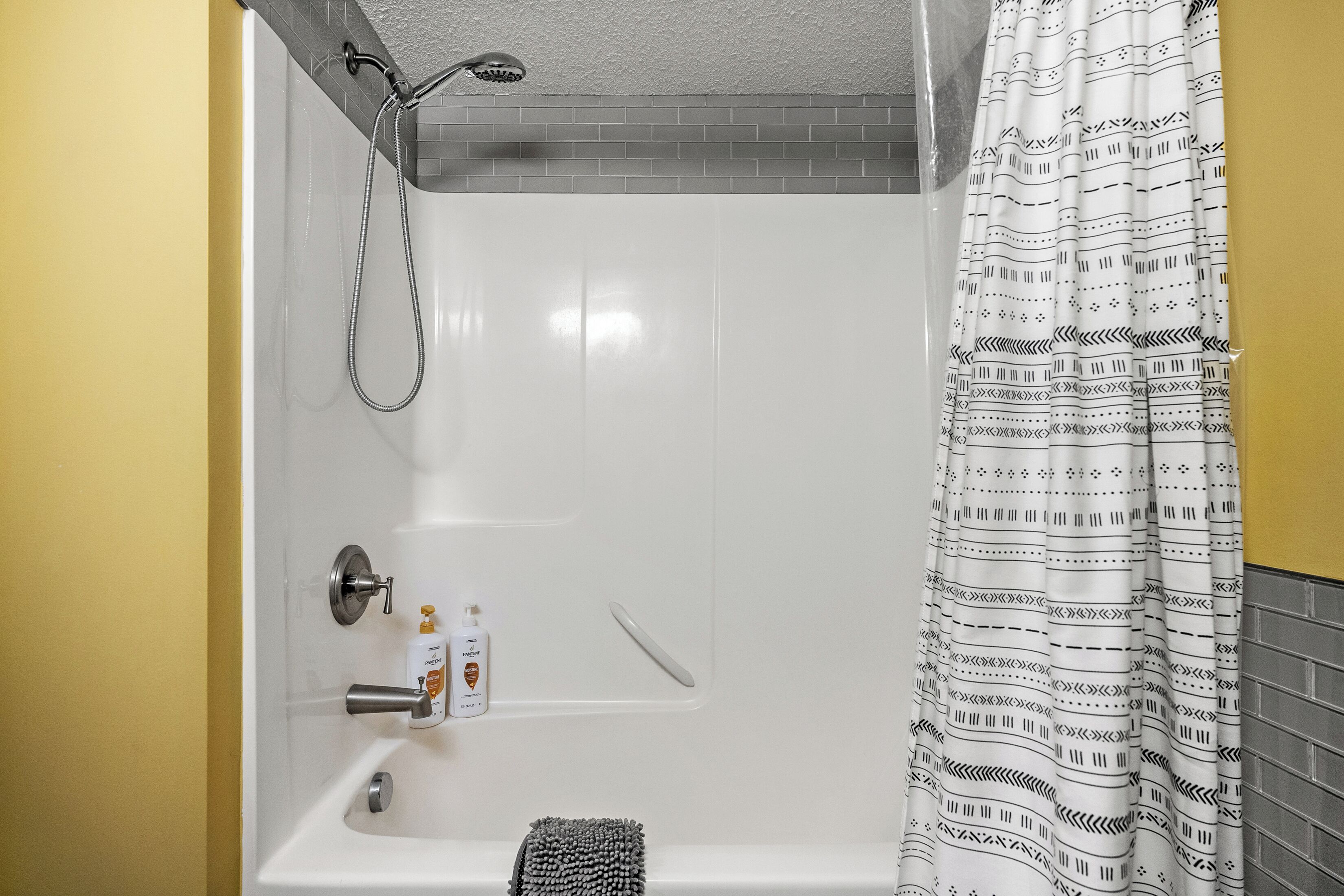 A bathroom with a shower, a toilet, and a sink.