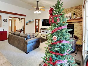 Relax in style with a comfortable sofa, flat-screen TV, and cozy fireplace.