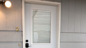A white door with a window and a small step leading up to it. - Morning Coffee with the quail.  Great views, excellent trails, and work friendly (Grand Junction)