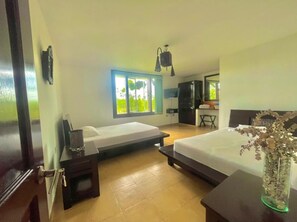 A hotel room with two single beds, a desk, a chair, a TV, and a window with a view of greenery. - Beautifull villa with private pool in Quindio (Quimbaya/ quindio / colombia)