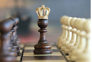 A close-up of a chessboard with a single king piece in focus.