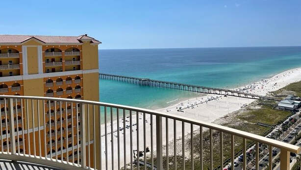 A beachfront hotel with a pier extending into the ocean, offering ocean views.