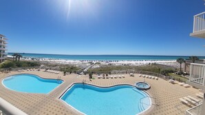 A pool area with two pools, a beach view, and a sun deck with lounge chairs. - Exceptional Luxury Gulf-Front Condo at Summer Place! (Fort Walton Beach)