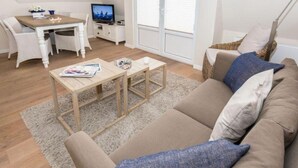 A modern living room with a sofa, coffee table, and TV.