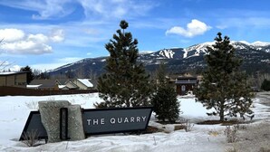 A sign reading 'THE QUARRY' with a mountainous backdrop and snow-covered ground. - 40 Mins to Glacier Park, 5 Mins to City Beach & DT (Whitefish)